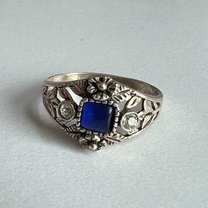 Vintage-style ornate ring with blue stone